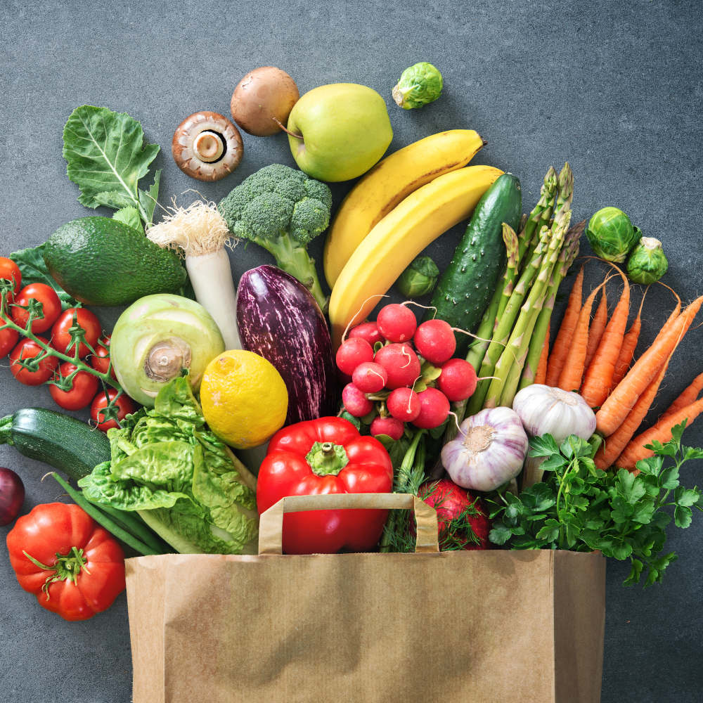 Shopping bag full of fresh vegetables and fruits featured